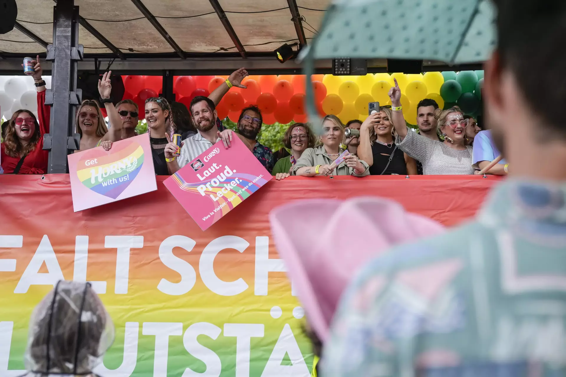 Mehrere Personen auf dem CSD-Truck mit bunten Schildern mit Vielfalts-Botschaften
